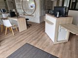 a desk with a computer and a chair in the room