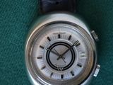 a watch that is sitting on a green surface