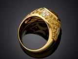 a close up of a gold ring with diamonds on a black background