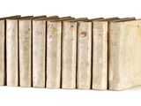 plusieurs vieux livres sont alignés sur une surface blanche