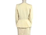 an image of a mannequin dressed in a beige suit and skirt