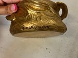 a person that is holding a gold cup