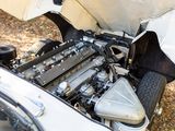 a white car with a engine in the trunk of it