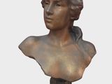 a bronze bust of a woman with a bird on her head
