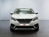 the front view of a white car in a white room