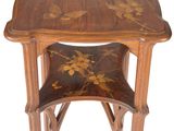 a small wooden table with a floral design on it