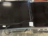 two laptops sitting on top of each other on a table