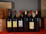 several bottles of red wine are lined up on a table
