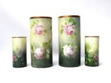 four vases with flowers painted on them on a white background