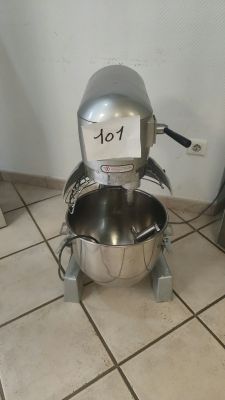 a mixer sitting on the floor in the kitchen