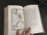a person holding an open book with a map on it