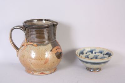 a pitcher and bowl sitting next to each other on a table