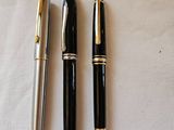 two pens sitting next to each other on a table