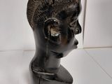 sculpture of a woman ' s head on a marble base