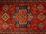 a close up of a red and blue rug with a pattern on it
