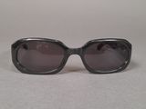 black sunglasses on a table with a white background