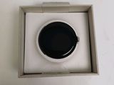 a small black object in a white box on a table