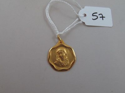 a close up of a gold medal on a string with a price tag