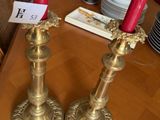 two candles that are sitting on a wooden table
