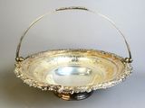 a silver plate with a handle on a table