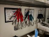 many utensils hanging on the wall in the kitchen