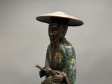 a statue of a woman with a hat and holding a guitar