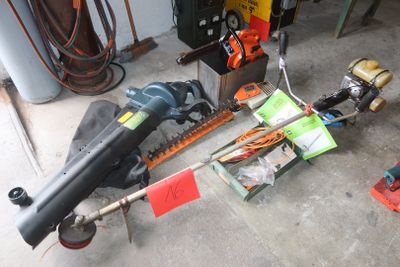 a picture of a chainsaw and other tools in a garage