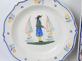 a plate with a painting of a man on it