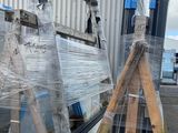 many pieces of plastic on a pallet next to a building