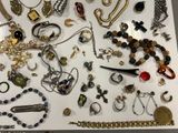 many different types of jewelry displayed on a table