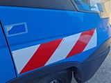a close up of a blue car with a red and white stripe