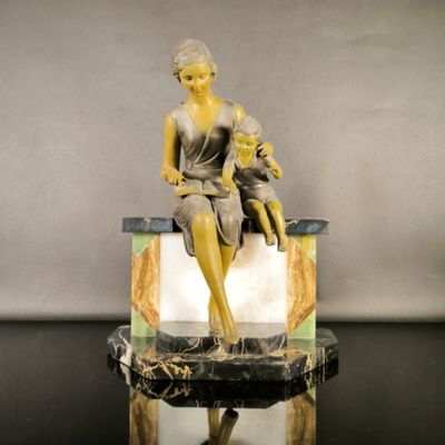 a statue of a woman and a child sitting on a bench