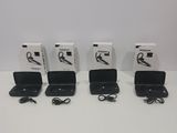 four black laptops are lined up in a row on a white surface
