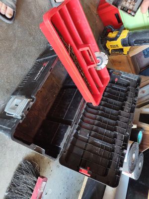 a red tool box with tools in it sitting on the floor