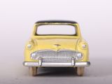 a yellow toy car that is sitting on a table
