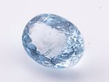 a close up of a blue topazte stone on a white surface