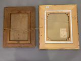 two framed pictures of a couple of frames on a wall