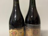 two bottles of wine sitting next to each other on a table