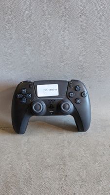a video game controller sitting on the floor next to a wall