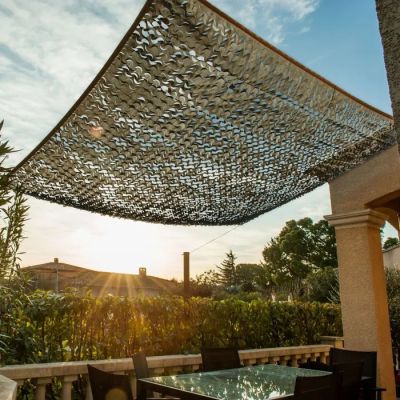 an image of a patio with a table and chairs under a sun shade