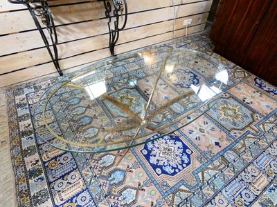 a glass table with a glass top sitting on a rug