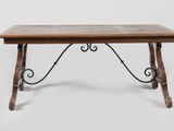 an old wooden table with iron legs and a tile top
