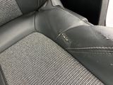 a close up of a car seat with holes in it