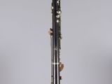 a close up of a bassoon on a stand on a white surface