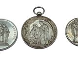three silver medals of jesus and mary on a white background