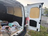 a van that has a bunch of items in the back of it
