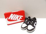 pair of black and white nike shoes next to a box of red and white shoes