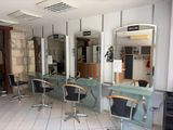 an image of a hair salon with chairs and mirrors