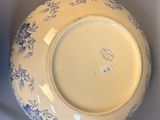 a blue and white bowl sitting on a white surface