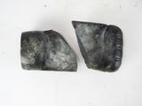 two pieces of stone are sitting next to each other on a white surface